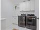 Well-lit laundry room featuring modern washer and dryer units, cabinets, and a sink area at 4356 N Buckhead Ne Dr, Atlanta, GA 30342