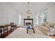 Spacious living room with fireplace, hardwood floors, modern lighting, and comfortable seating at 4356 N Buckhead Ne Dr, Atlanta, GA 30342