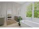 Bright main bathroom featuring a soaking tub, large window, and views into the main bedroom at 4356 N Buckhead Ne Dr, Atlanta, GA 30342