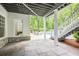 Covered patio with stone flooring overlooking the landscaped backyard and pool at 4356 N Buckhead Ne Dr, Atlanta, GA 30342