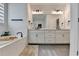 Large bathroom with double vanity, soaking tub, and lots of light at 4391 Encore Blvd, Duluth, GA 30097
