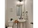 Powder room with a pedestal sink, mirror, and toilet at 4391 Encore Blvd, Duluth, GA 30097