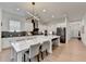 Elegant kitchen with a large island, bar stool seating, stainless steel appliances, and stylish overhead lighting at 4391 Encore Blvd, Duluth, GA 30097