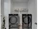 Laundry room featuring a washer and dryer set and storage; a practical space for efficient laundry at 4391 Encore Blvd, Duluth, GA 30097