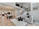 Open-concept living area showcasing hardwood floors, a staircase, a sectional sofa, and a view of the kitchen at 4391 Encore Blvd, Duluth, GA 30097