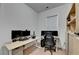 A well-lit home office featuring a large desk, multiple monitors, and shelving for storage and organization at 4391 Encore Blvd, Duluth, GA 30097