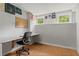 Finished basement area with built-in desk, office chair, two windows and laminate floors at 1145 Cool Springs Nw Dr, Kennesaw, GA 30144
