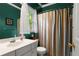 Cozy bathroom with single vanity, toilet, and shower-tub combo behind a vibrant curtain at 1145 Cool Springs Nw Dr, Kennesaw, GA 30144