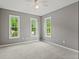 Sunny bedroom with soft carpet, neutral paint, and three windows offering bright natural light and outdoor views at 1145 Cool Springs Nw Dr, Kennesaw, GA 30144