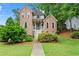 Charming two-story brick home featuring a well-manicured lawn and mature landscaping at 1145 Cool Springs Nw Dr, Kennesaw, GA 30144