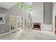 Bright living room featuring a fireplace, tall ceilings, and a wall of windows at 1145 Cool Springs Nw Dr, Kennesaw, GA 30144