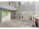 Spacious living room with a fireplace, tall ceilings, and access to the outdoor deck at 1145 Cool Springs Nw Dr, Kennesaw, GA 30144