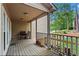 Covered porch featuring grill, wood pile, and wood railing at 1145 Cool Springs Nw Dr, Kennesaw, GA 30144