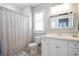 Bathroom with a single vanity, a toilet, a tub with white subway tile, and striped shower curtain at 3042 Jefferson St, Atlanta, GA 30341
