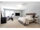 Bedroom featuring a tufted headboard, carpet floors, a spinning bike, and plenty of natural light at 3042 Jefferson St, Atlanta, GA 30341