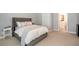 Bedroom with a tufted headboard bed, and a view to a small bathroom at 3042 Jefferson St, Atlanta, GA 30341