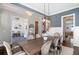 Elegant dining room featuring a large wooden table with seating for eight, complemented by stylish lighting and décor at 3042 Jefferson St, Atlanta, GA 30341