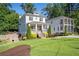 Charming two-story home featuring a welcoming front porch, manicured landscaping, and a lush green lawn at 3042 Jefferson St, Atlanta, GA 30341