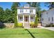 Charming two-story home with a welcoming front porch, manicured lawn, and lush landscaping at 3042 Jefferson St, Atlanta, GA 30341