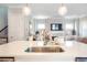 Bright, open kitchen featuring a white quartz island, stainless steel sink, and globe pendant lighting at 3042 Jefferson St, Atlanta, GA 30341