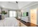 Bright main bedroom with a tray ceiling, large window, wood floors, and an ensuite bathroom with glass shower at 3042 Jefferson St, Atlanta, GA 30341
