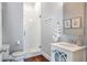 Elegant powder room featuring a marble shower, sink, and wood floors at 3042 Jefferson St, Atlanta, GA 30341
