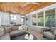 Inviting sunroom with wood ceiling, comfortable seating, and backyard views at 3042 Jefferson St, Atlanta, GA 30341