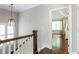 Upstairs hallway showcasing hardwood floors and a view of the primary bedroom at 3042 Jefferson St, Atlanta, GA 30341