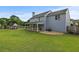 Expansive backyard featuring a manicured lawn, playhouse, and covered deck at 406 Mount Vernon Ct, Woodstock, GA 30189