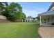 Lush backyard offering a well-maintained lawn, privacy fence, mature trees, and a charming playhouse at 406 Mount Vernon Ct, Woodstock, GA 30189