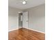 Neutral bedroom with hardwood floors, neutral paint and open doorway at 406 Mount Vernon Ct, Woodstock, GA 30189