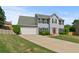 This property showcases a spacious driveway and a neatly kept front lawn at 406 Mount Vernon Ct, Woodstock, GA 30189