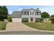 Well-maintained home featuring a large driveway and inviting front lawn at 406 Mount Vernon Ct, Woodstock, GA 30189