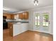 Bright kitchen features wood cabinets, tile countertops, and a door leading to the backyard at 406 Mount Vernon Ct, Woodstock, GA 30189