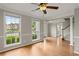 Spacious living room with hardwood floors, large windows, and a ceiling fan at 406 Mount Vernon Ct, Woodstock, GA 30189