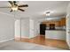 Living room with kitchen in the background and french doors to backyard at 406 Mount Vernon Ct, Woodstock, GA 30189