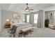 Staged main bedroom boasts tray ceilings, ceiling fan, and soft natural light at 406 Mount Vernon Ct, Woodstock, GA 30189