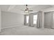 Large main bedroom with tray ceiling, ceiling fan, and two windows at 406 Mount Vernon Ct, Woodstock, GA 30189