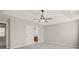 Bright and airy main bedroom featuring a ceiling fan and easy access to the bathroom at 406 Mount Vernon Ct, Woodstock, GA 30189