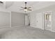 Large main bedroom with tray ceiling, ceiling fan, and easy access to the bathroom at 406 Mount Vernon Ct, Woodstock, GA 30189