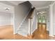 Open foyer featuring staircase with hardwood floors and views into adjacent rooms at 406 Mount Vernon Ct, Woodstock, GA 30189