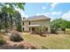 Spacious backyard features a covered patio, mature trees, and well-maintained lawn at 1745 Fairburn Dr, Cumming, GA 30040