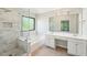 Bathroom featuring glass shower with tub, double sinks, tile floors, and vanity with storage at 1745 Fairburn Dr, Cumming, GA 30040