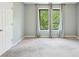 Spacious carpeted bedroom with two large windows offering natural light and neutral walls at 1745 Fairburn Dr, Cumming, GA 30040