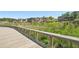 Scenic community with modern buildings, lush greenery, and a charming wooden walkway at 1745 Fairburn Dr, Cumming, GA 30040