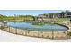 View of community pond with covered patio and walkway, offering a relaxing and scenic outdoor area at 1745 Fairburn Dr, Cumming, GA 30040