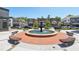 Community fountain with benches providing a relaxing outdoor gathering space surrounded by local businesses at 1745 Fairburn Dr, Cumming, GA 30040