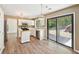 Modern kitchen with white cabinets, stainless steel appliances, hardwood floors, and a sliding door to the backyard at 1745 Fairburn Dr, Cumming, GA 30040