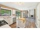 Open kitchen with stainless steel appliances, hardwood floors, natural light, and a view into the adjoining living space at 1745 Fairburn Dr, Cumming, GA 30040