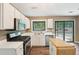 Bright kitchen featuring stainless steel appliances, white cabinets, and hardwood floors, perfect for cooking and dining at 1745 Fairburn Dr, Cumming, GA 30040